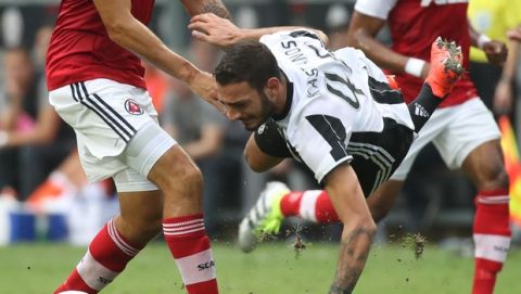 Grigoris Kastanos of Juventus FC, right, is tackled by Sean Tse of South China FC, left, during the International Challenge Cup, a friendly football match in Hong Kong, Saturday, July 30, 2016. (AP Photo/Kin Cheung)