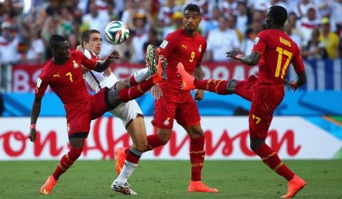 FORTALEZA, BRAZIL - JUNE 21: Philipp Lahm of Germany competes for the ball with Christian Atsu (L) and Mohammed Rabiu of Ghana (R) during the 2014 FIFA World Cup Brazil Group G match between Germany and Ghana at Castelao on June 21, 2014 in Fortaleza, Brazil.  (Photo by Robert Cianflone/Getty Images)