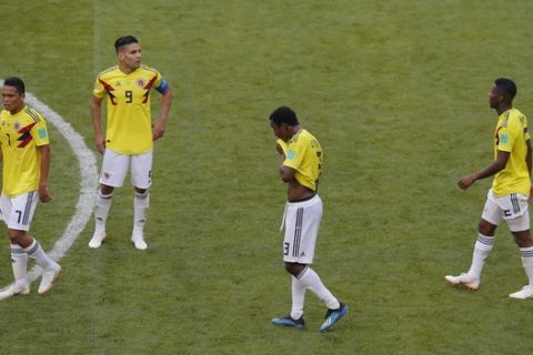 Colombia's Carlos Bacca, left, Radamel Falcao, 2nd left, Oscar Murillo, 2nd right, and Mateus Uribe, right, leave the pitch after loosing the group H match between Colombia and Japan at the 2018 soccer World Cup in the Mordavia Arena in Saransk, Russia, Tuesday, June 19, 2018. (AP Photo/Vadim Ghirda)