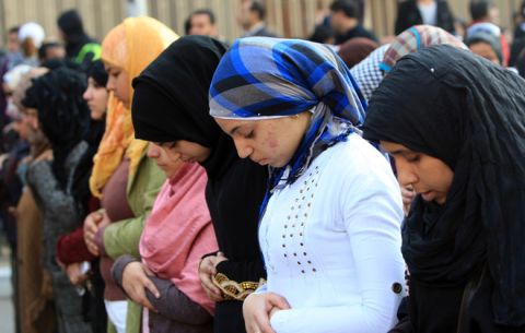 Egyptian women pray outside Al-Ahly club in Cairo on February 2, 2012 before marching to the ministry of interior in protest against the previous day's deadly riot after a football match. Egypt began three days of mourning after 74 people were killed in an eruption of violence at a football match between Al-Ahly and Al-Masry clubs that sparked new anger against the military rulers for failing to ensure security. AFP PHOTO/MAHMUD HAMS (Photo credit should read MAHMUD HAMS/AFP/Getty Images)