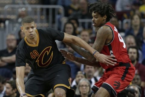 Cleveland Cavaliers' Edy Tavares (40) drives past Toronto Raptors' Lucas Nogueira (92), from Brazil, in the second half of an NBA basketball game, Wednesday, April 12, 2017, in Cleveland. (AP Photo/Tony Dejak)