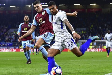 Burnley's Matthew Lowton, left, and Chelsea's Emerson Palmieri in action during the English Premier League soccer match at Turf Moor, in Burnley, England, Thursday April 19, 2018.(Anthony Devlin/PA via AP)