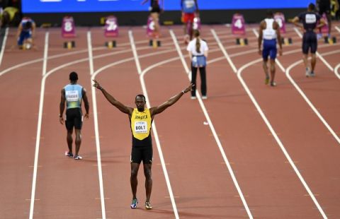 Jamaica's Usain Bolt gestures to the crowd ahead of his heat in the Men's 100 meters during the World Athletics Championships in London Friday, Aug. 4, 2017. (AP Photo/Martin Meissner)