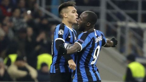 Inter Milan's Romelu Lukaku, right, celebrates with his teammate Inter Milan's Lautaro Martinez after scoring his side's opening goal during the Champions League, group F soccer match between Inter Milan and F.C. Barcelona, at the San Siro stadium in Milan, Italy, Tuesday, Dec. 10, 2019. (AP Photo/Luca Bruno)