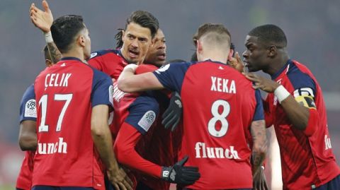 Lille players celebrate after PSG's Thomas Meunier scored an own goal during the French League One soccer match between OSC Lille and Paris-Saint-Germain at Stade Pierre Mauroy in Lille, France, Sunday, April 14, 2019.(AP Photo/Michel Spingler)