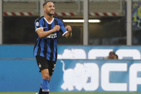 Inter Milan's Danilo D'Ambrosio celebrates after he scored his side's first goal during a Serie A soccer match between Inter Milan and Lazio, at the San Siro stadium in Milan, Italy, Wednesday, Sept. 25, 2019. (AP Photo/Antonio Calanni)