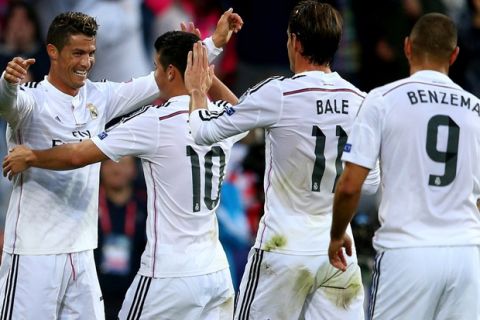 CARDIFF, WALES - AUGUST 12:  (L-R) Cristiano Ronaldo of Real Madrid celebrates with teammates James Rodriguez, Gareth Bale and Karim Benzema after scoring the opening goal during the UEFA Super Cup between Real Madrid and Sevilla FC at Cardiff City Stadium on August 12, 2014 in Cardiff, Wales.  (Photo by Clive Mason/Getty Images)