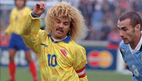 Colombian soccer player Carlos Valderrama, left, battles for the ball with Uruguay's Paolo Montero, during the game played, Sunday June 8, 1997, in Montevideo, Uruguay, for the qualify World Cup France,1998. (AP Photo/Daniel Muzio)