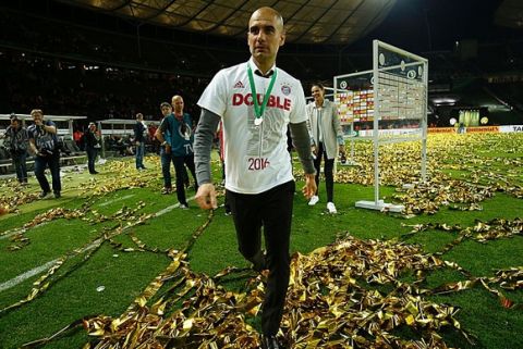 Bayern Munich's Spanish head coach Pep Guardiola walks on the pitch after winning the German Cup (DFB Pokal) final football match Bayern Munich vs Borussia Dortmund at the Olympic stadium in Berlin on May 21, 2016. / AFP / ODD ANDERSEN / RESTRICTIONS: ACCORDING TO DFB RULES IMAGE SEQUENCES TO SIMULATE VIDEO IS NOT ALLOWED DURING MATCH TIME. MOBILE (MMS) USE IS NOT ALLOWED DURING AND FOR FURTHER TWO HOURS AFTER THE MATCH. == RESTRICTED TO EDITORIAL USE == FOR MORE INFORMATION CONTACT DFB DIRECTLY AT +49 69 67880

 /         (Photo credit should read ODD ANDERSEN/AFP/Getty Images)
