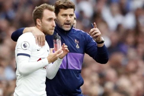 Tottenham's manager Mauricio Pochettino, center, gives instructions to Tottenham's Christian Eriksen during the English Premier League soccer match between Tottenham Hotspur and Aston Villa at the Tottenham Hotspur stadium in London, Saturday, Aug. 10, 2019. (AP Photo/Frank Augstein)