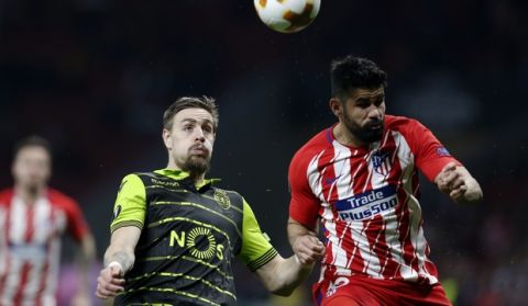 Sporting's Sebastian Coates vies for the ball with Atletico's Diego Costa, right, during the Europa League quarterfinal first leg soccer match between Atletico Madrid and Sporting CP at the Metropolitano stadium in Madrid, Thursday, April 5, 2018. (AP Photo/Francisco Seco)