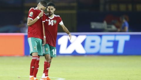 Morocco's Hakim Ziyach. left, and M'brak Boussoufa leave pitch dejected after the African Cup of Nations round of 16 soccer match between Morocco and Benin in Al Salam stadium in Cairo, Egypt, Friday, July 5, 2019. (AP Photo/Ariel Schalit)