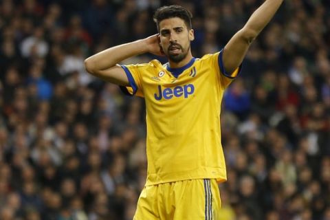 Juventus' Sami Khedira, right, reacts during a Champions League quarter final second leg soccer match between Real Madrid and Juventus at the Santiago Bernabeu stadium in Madrid, Wednesday, April 11, 2018. (AP Photo/Francisco Seco)