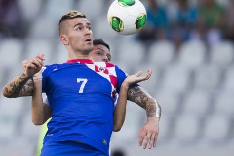 Croatias's Marko Livaja, front, and Chile's Mario Larenas, background, challenge for the ball during the Under-20 World Cup round of 16 soccer match between Croatia and Chile in Bursa, Turkey, Wednesday, July 3, 2013. (AP Photo/Gero Breloer)