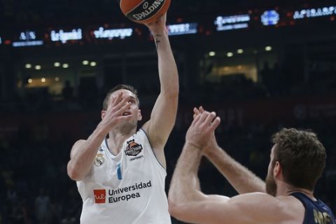 Real Madrid's Fabien Causeur tries to score as Fenerbahce's Nicolo Melli tries to block him during their Final Four Euroleague final basketball match between Real Madrid and Fenerbahce in Belgrade, Serbia, Sunday, May 20, 2018. (AP Photo/Darko Vojinovic)
