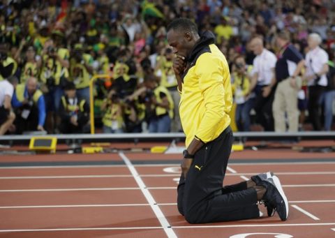 Jamaica's Usain Bolt pauses on the finish line during a lap of honor at the end of the World Athletics Championships in London Sunday, Aug. 13, 2017. (AP Photo/Matthias Schrader)