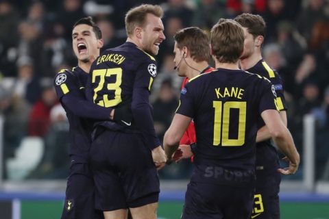 Tottenham's Christian Eriksen, 2nd left, celebrates with teammate Erik Lamela and Harry Kane, right, after scoring his side's second goal during the Champions League, round of 16, first-leg soccer match between Juventus and Tottenham Hotspurs, at the Allianz Stadium in Turin, Italy, Tuesday, Feb. 13, 2018. (AP Photo/Antonio Calanni)