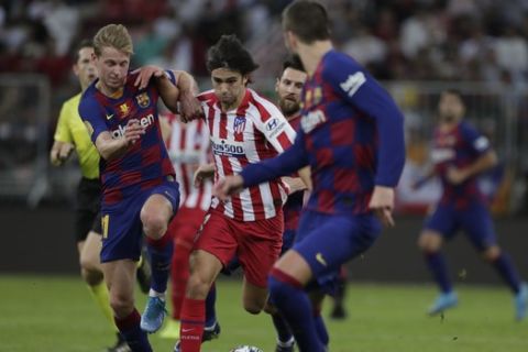 Atletico Madrid's Joao Felix, right, fights for the ball with Barcelona's Frenkie de Jong during the Spanish Super Cup semifinal soccer match between Barcelona and Atletico Madrid at King Abdullah stadium in Jiddah, Saudi Arabia, Friday, Jan. 10, 2020. (AP Photo/Amr Nabil)