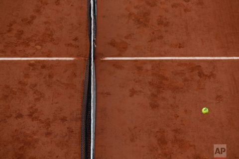 In this Saturday, June 3, 2017 photo, a ball flies over the net as South Africa's Kevin Anderson plays against Britain's Kyle Edmund during their third round match of the French Open tennis tournament at the Roland Garros stadium, in Paris, France. (AP Photo/Petr David Josek)
