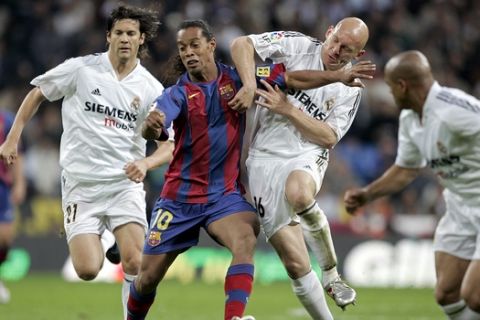 ** FILE ** Real Madrid player Thomas Gravesen from Denmark, second right, duels for the ball with FC Barcelona player Ronaldinho from Brazil, second left, as Real Madrid players Roberto Carlos from Brazil, right, and Santiago Solari from Argentina, left, look on during their Spanish league soccer match in Madrid, Sunday, April 10, 2005. Ronaldinho is on the shortlist for FIFA's world player of the year which will be announced in Zurich, Switzerland Monday Dec. 19, 2005. (AP Photo/Jasper Juinen) ** EFE OUT **