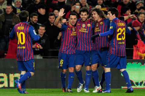 Barcelona's midfielder Xavi Hernandez (2L) celebrates with teammate after scoring during the Spanish Cup second leg semi-final football match FC Barcelona vs Valencia CF on February 8, 2012 at the Camp Nou stadium in Barcelona.  AFP PHOTO / JOSEP LAGO (Photo credit should read JOSEP LAGO/AFP/Getty Images)