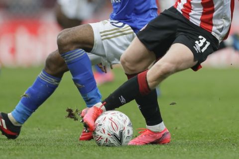 Brentford's Jan Zamburek challenges for the ball with Leicester's Hamza Choudhury during the English FA Cup fourth round soccer match between Brentford FC and Leicester City at Griffin Park stadium in London, Saturday, Jan. 25, 2020. (AP Photo/Kirsty Wigglesworth)