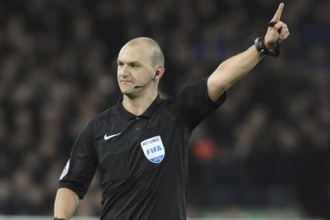 Referee Robert Madley during the English FA Cup Third Round soccer match between Liverpool and Everton at Anfield in Liverpool, England, Friday, Jan. 5, 2018. (AP Photo/Rui Vieira)