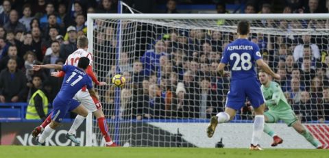 Chelsea's Pedro, no. 11, watches as his shot goes in for his side's 3rd goal during their English Premier League soccer match between Chelsea and Stoke City in London, Saturday, Dec. 30, 2017. (AP Photo/Alastair Grant)
