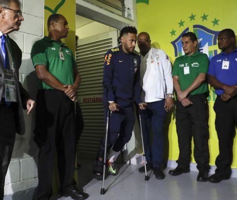 Brazil's Neymar walks out of the lockeroom using crutches after sustaining an injury during a friendly soccer match against Qatar at the Estadio Nacional in Brasilia, Brazil, Wednesday, June 5, 2019.(AP Photo/Andre Penner)