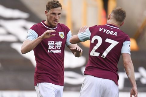 Burnley's Chris Wood, left, celebrates scoring their first goal with Matej Vydra during the English Premier League soccer match between Wolves and Burnley at the Molineux Stadium in Wolverhampton, England, Sunday, April 25, 2021. (Oli Scarff/Pool via AP)