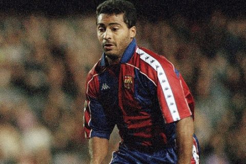 Barcelona's Brazilian striker Romario (r) gets the better of Jose Mari Garcia of Osasuna in a first division soccer match on Saturday, Feb. 19, 1994 in Barcelona. Romario went on to score three goals as Barcelona hit form in an impressive 8-1 victory. (AP Photo/Amilcar de Leon)