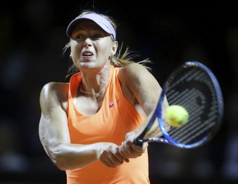 Russia's Maria Sharapova hits a backhand against Italy's Roberta Vinci at the Porsche Tennis Grand Prix in Stuttgart, Germany, Wednesday, April 26, 2017. It is Sharapova's first match after a 15 months lasting doping ban. (AP Photo/Michael Probst)