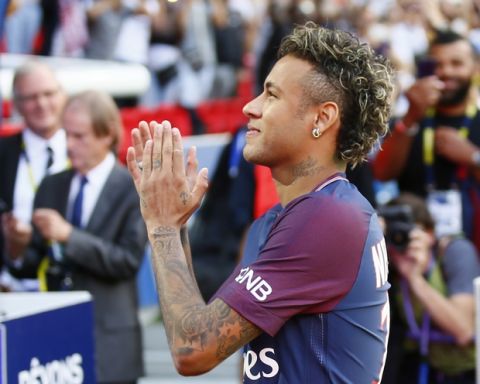 Brazilian soccer star Neymar applauds his fans at the Parc des Princes stadium in Paris, Saturday, Aug. 5, 2017, during his official presentation to fans ahead of Paris Saint-Germain's season opening match against Amiens. Neymar would not play in the club's season opener as the French football league did not receive the player's international transfer certificate before Friday's night deadline. The Brazil star became the most expensive player in soccer history after completing his blockbuster transfer from Barcelona for 222 million euros ($262 million) on Thursday. (AP Photo/Francois Mori)