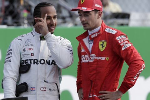 Ferrari driver Charles Leclerc of Monaco, right, talks with Mercedes driver Lewis Hamilton of Britain after the qualifying session at the Monza racetrack, in Monza, Italy, Saturday, Sept. 7, 2019. The Formula one race will be held on Sunday. (AP Photo/Luca Bruno)