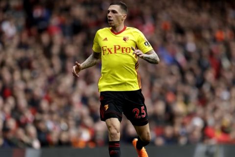 Watford's Jose Holebas reacts after clashing with Arsenal's Mesut Ozil during the English Premier League soccer match between Arsenal and Watford at the Emirates stadium in London, Sunday, March 11, 2018. (AP Photo/Matt Dunham)