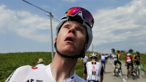 Britain's Chris Froome grimaces after being treated for tear gas or pepper spray sprayed on the peloton when a farmer's protest interrupted during the sixteenth stage of the Tour de France cycling race over 218 kilometers (135.5 miles) with start in Carcassonne and finish in Bagneres-de-Luchon, France, , Tuesday, July 24, 2018. (AP Photo/Peter Dejong)