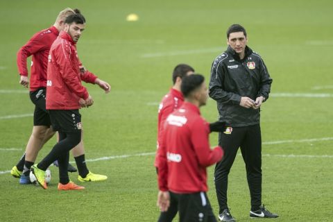 Leveerkusen's new coach  Tayfun Korkut, right, attends a  team training session in Leverkusen, Germany, Monday, March 6, 2017.  Bayer Leverkusen has hired former Turkey international Tayfun Korkut as coach to rescue something from the club's worst Bundesliga season in 14 years. Leverkusen says the 42-year-old Korkut, previously coach of Hannover and then second-division club Kaiserslautern, has signed a deal until the end of the season, along with assistant coach Xaver Zembrod. (Federico Gambarini/dpa via AP)