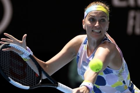 Petra Kvitova of the Czech Republic makes a backhand return to Australia's Ashleigh Barty during their quarterfinal match at the Australian Open tennis championship in Melbourne, Australia, Tuesday, Jan. 28, 2020. (AP Photo/Andy Brownbill)
