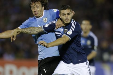 Argentina's Mauro Icardi, right, fight for the ball with Uruguay's Diego Lugano during a 2014 World Cup qualifying soccer match  in Montevideo, Uruguay, Tuesday, Oct. 15, 2013. (AP Photo/Natacha Pisarenko)