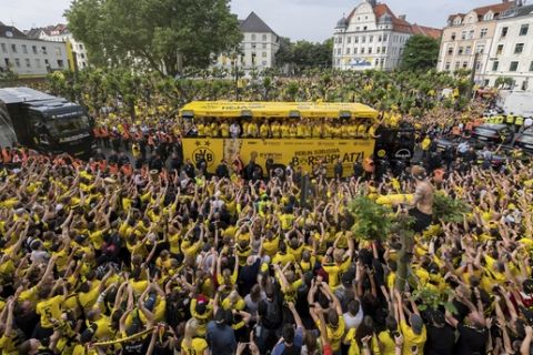 The truck with Borussia Dortmund players arrives at the Borsigplatz place where numerous fans are waiting in Dortmund, Germany, Sunday, May28, 2017, after they won the German soccer cup on Saturday against Eintracht Frankfurt in Berlin. (Guido Kirchner/dpa via AP)