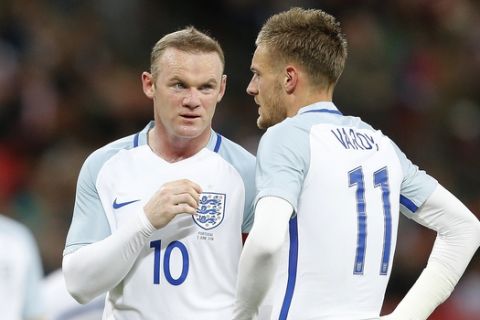 England's Wayne Rooney, center, talks to England's Jamie Vardy during the International friendly soccer match between England and Portugal at Wembley stadium in London, England, Thursday, June 2, 2016 . (AP Photo/Frank Augstein)
