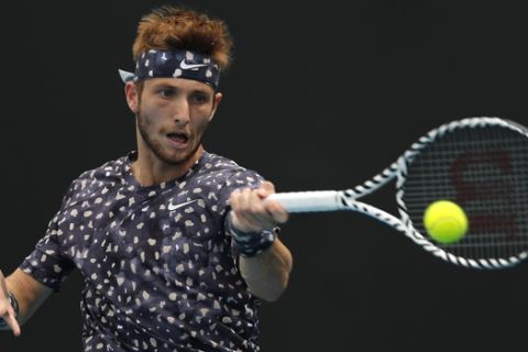 France's Corentin Moutet makes a forehand return to Croatia's Marin Cilic during their first round singles match at the Australian Open tennis championship in Melbourne, Australia, Tuesday, Jan. 21, 2020. (AP Photo/Andy Wong)