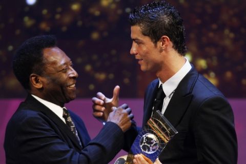 Soccer player Cristiano Ronaldo from Portugal, right, receives the trophy from former Brazilian soccer star Pele, left, after being named FIFA World Player of the Year during the FIFA World Player Gala 2008 at the Opera house in Zurich, Switzerland, Monday, Jan. 12, 2009. (AP Photo/KEYSTONE/Steffen Schmidt)