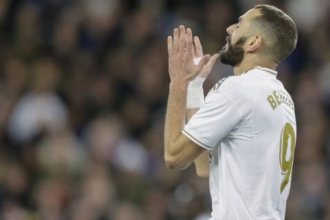 Real Madrid's Karim Benzema reacts after failing a scoring chance during a Spanish La Liga soccer match between Real Madrid and Athletic Bilbao at the Santiago Bernabeu stadium in Madrid, Spain, Sunday Dec. 22, 2019. (AP Photo/Paul White)