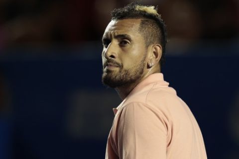 Australia's Nick Kyrgios, the tournament's defending champion, walks on the court during his Round 1 match against France's Ugo Humbert, shortly before pulling out of the Mexican Tennis Open at the end of his first set citing an injury, in Acapulco, Mexico, Tuesday, Feb. 25, 2020.(AP Photo/Rebecca Blackwell)