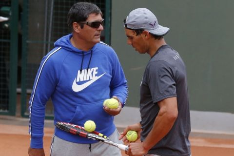 Spain's Rafael Nadal, right, listens to his coach and uncle Toni Nadal during a training session for the French Open tennis tournament, at the Roland Garros stadium in Paris, Saturday, May 24, 2014. The French Open tennis tournament starts Sunday. (AP Photo/Michel Euler)