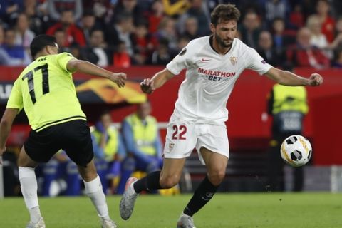 Sevilla's Franco Vazquez, right, fights for the ball with Dudelange's Sabir Bougrine during the Europa League group A soccer match between Sevilla and Dudelange at the Estadio Ramon Sanchez-Pizjuan stadium in Seville, Spain, Thursday, Oct. 24, 2019. (AP Photo/Miguel Morenatti)
