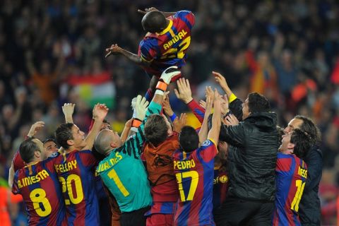 Barcelona's players toss teammate Barcelona's French defender Eric Abidal after winning the Champions League semi-final second leg football match between Barcelona and Real Madrid at the Camp Nou stadium in Barcelona on May 3, 2011. Barcelona qualified for the Champions League final after drawing 1-1 in their semi-final second leg clash with bitter rivals Real Madrid to progress 3-1 on aggregate. AFP PHOTO/LLUIS GENE (Photo credit should read LLUIS GENE/AFP/Getty Images)