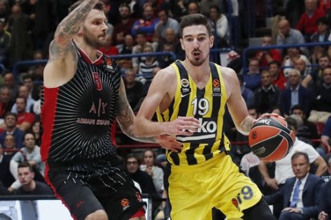 Olimpia Milan's Vladimir Micov, left, challenges for the ball with Fenerbahce's Nando De Colo during the Euro League basketball match between Olimpia Milan and Fenerbahce, in Milan, Italy, Friday, Oct. 25, 2019. (AP Photo/Antonio Calanni)