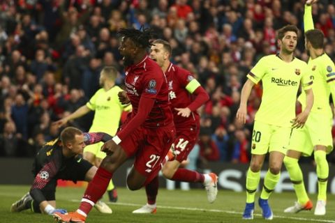 Liverpool's Divock Origi reacts next to Jordan Henderson during the Champions League semifinal, second leg, soccer match between Liverpool and FC Barcelona at the Anfield stadium in Liverpool, England, Tuesday, May 7, 2019. (AP Photo/Dave Thompson)